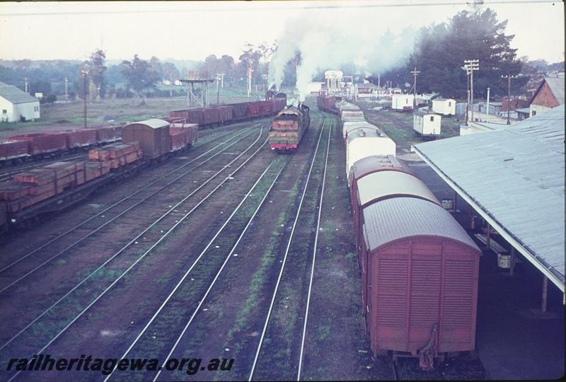P09682
Water tower, signals, part view of platform and station building, view of yard, departing double headed mines shunter, double headed light engines. Collie station yard. BN line.
