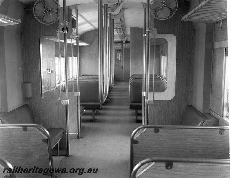 P10420
Interior view of ADB class railcar showing electric fans and crush barriers. Door opening button on left.

