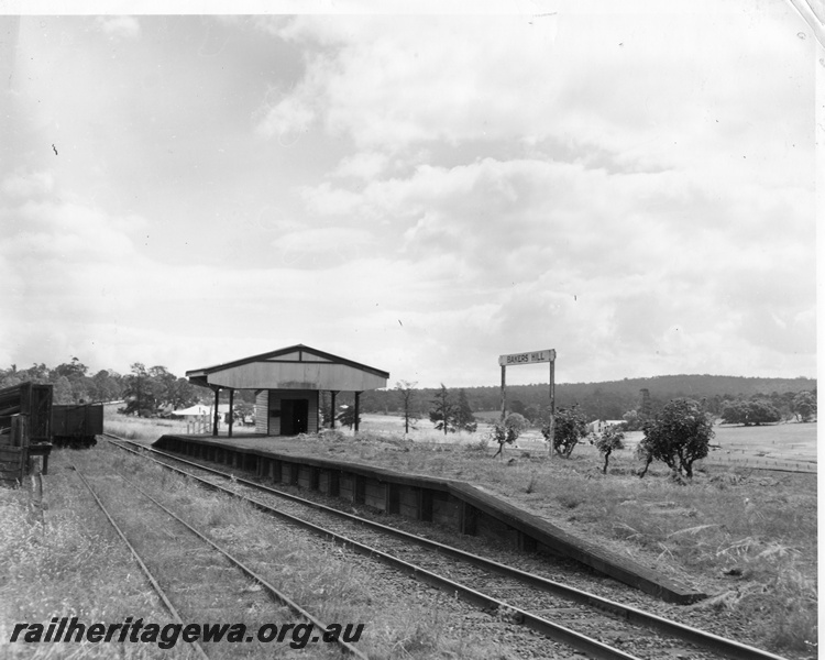 P10421
Platform at Bakers Hill showing canopy over building, station signboard, up main line, goods siding with wagon and portion of loading ramp for sheep/cattle.ER line

