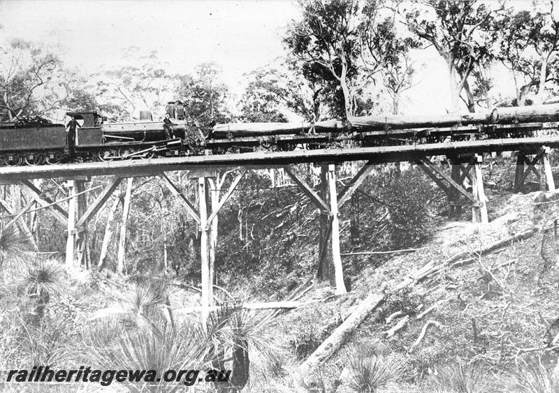 P10504
WAGR 2-6-0 G class loco hauling WAGR M class four wheel bolster wagons over a trestle bridge between the forest and the saw mill at Drakes Brook, later Waroona (ref: Rails Through the Bush, 2nd edition, page 79)
