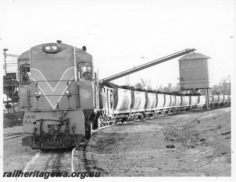 P10537
RA class 1915 diesel locomotive loading a rake of XG class coal hoppers destined for SEC at Kwinana. Front view of locomotive.
