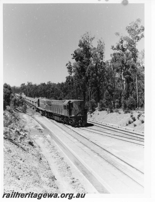 P10593
Two D class diesel locomotives hauling a loaded bauxite train on departure from Jarrahdale enroute to Kwinana.
