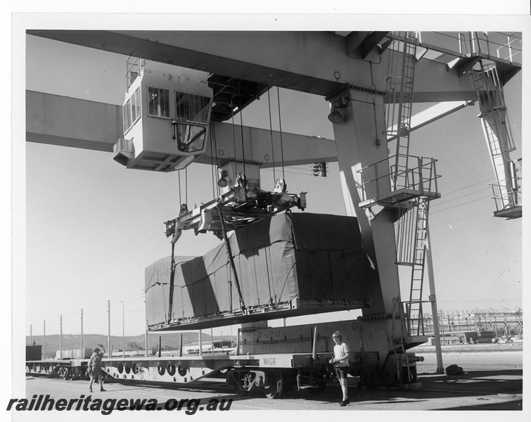 P10607
WFX class standard gauge flat top wagon being unloaded by gantry crane at Kewdale Freight Terminal.
