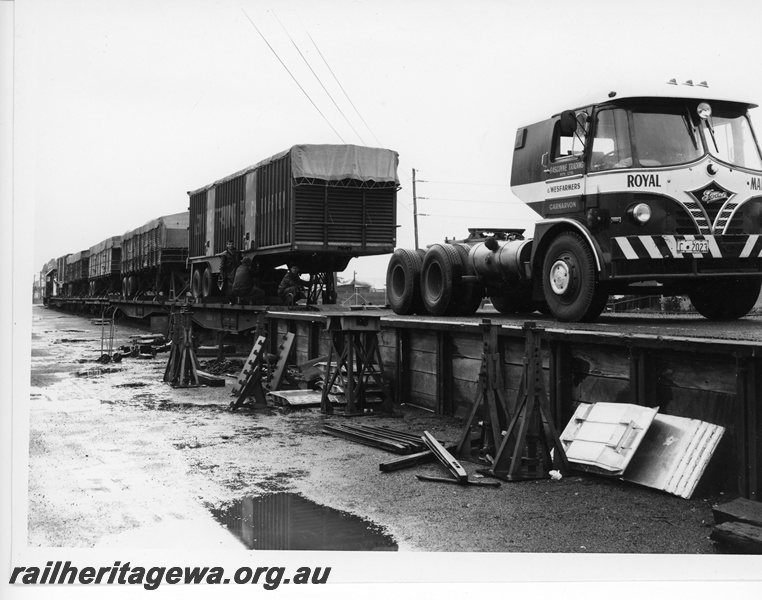 P10615
Gascoyne Traders Foden prime mover reversing onto a QU class flat top wagon to unload a trailer at Geraldton.

