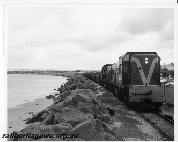 P10619
A class 1511 narrow gauge diesel locomotive, with a sibling unit, with a loaded goods train travelling along the waterfront at Geraldton.
