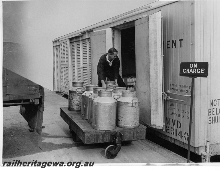 P10626
WVD class 23140 chiller van being loaded with milk at Perth Parcels in Roe Street. The electric refrigeration unit of the van is on charge as the loading takes place.
