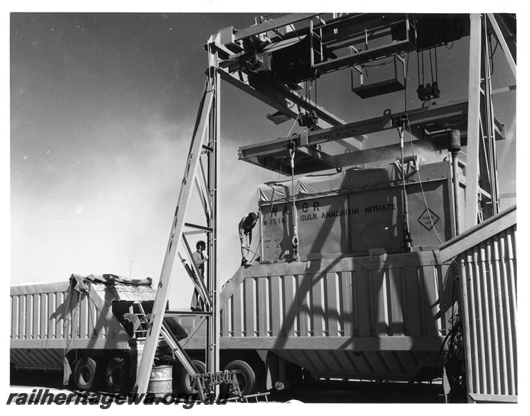 P10638
Bulk ammonium nitrate container No. 1516, being emptied into road trailer, WAGR SWL 18 ton overhead gantry crane, Meekatharra, side and end view 
