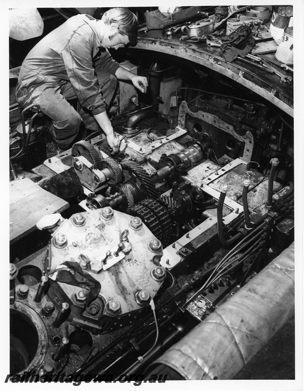 P10653
Diesel locomotive engine being overhauled, mechanic, Midland Workshops, close up view
