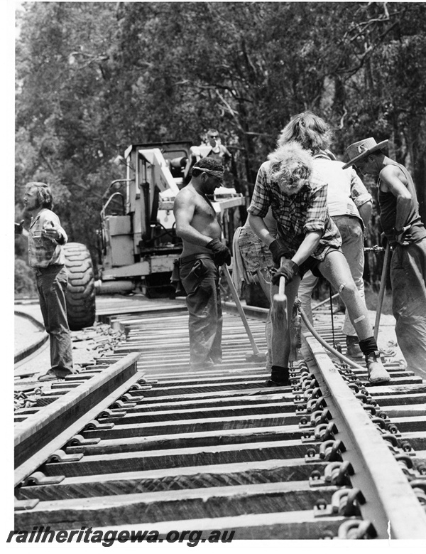 P10654
Line straightening operations, track laying crew at work with sledge hammers, track laying machine, near Collie, BN line, close up view
