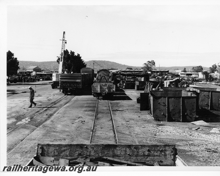 P10672
HC class wagon 21647, mobile crane, worker, other wagons, bins and other paraphernalia, Midland salvage yard, end view
