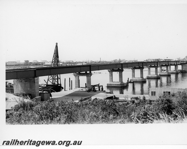 P10676
Concrete and steel bridge over Swan River, derrick, port in background, North Fremantle, ER line, view from bank
