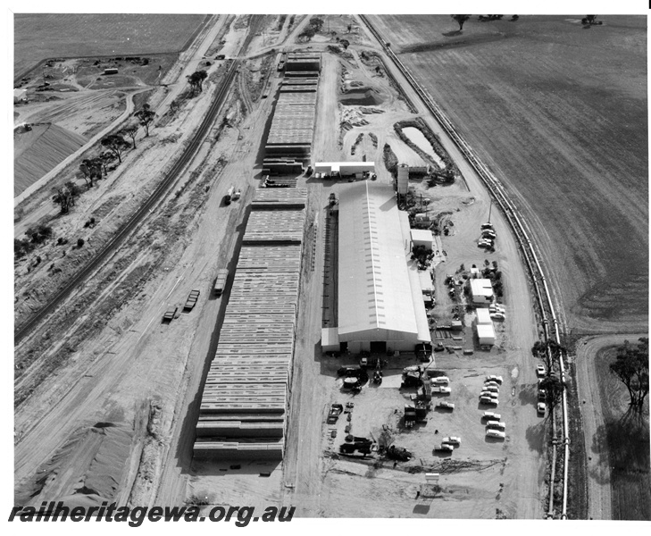 P10701
Aerial view of the standard gauge sleeper construction shed at Meckering. Stacked sleepers are awaiting transport to the railhead site.
