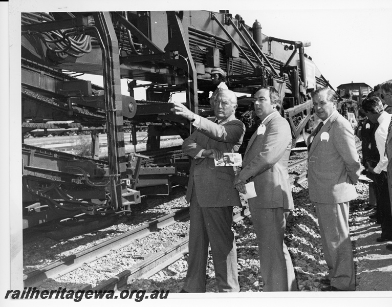 P10710
P811 tack renewal machine, Premier of WA, Sir Charles Court, Mr. P. Gill, WA State Manger for Roberts Contraction, Minister for Railways Hon. E. C. Rushton at the launch of the standard gauge rehabilitation project between Kwinana and Koolyanobbing. 
