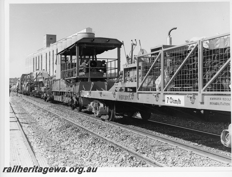 P10760
WSO class 30171 standard gauge equipment wagon in use with the P811 tracklaying machine at Avon Yard. Note the wheat silos in the background.
