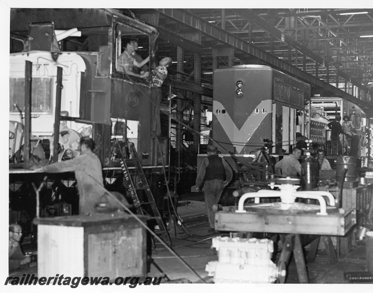 P10784
Locomotives under overhaul, workers, inspection by guidance officers, Diesel Shop, Midland Workshops, ground level view
