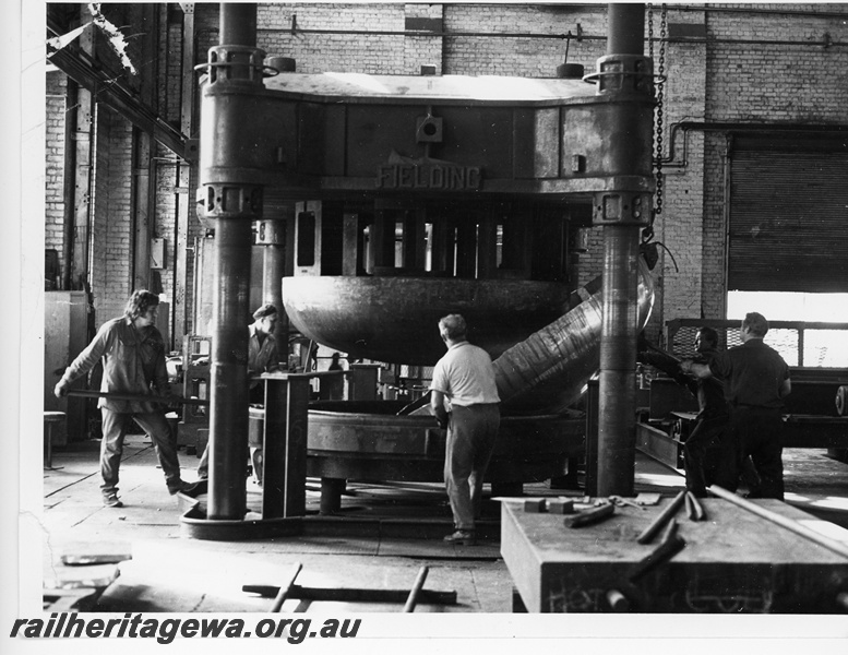 P10813
Pressing dished aluminium tank ends, Fielding press, workers including Jack Gibbons (far right), Flanging Shop, Midland Workshops
