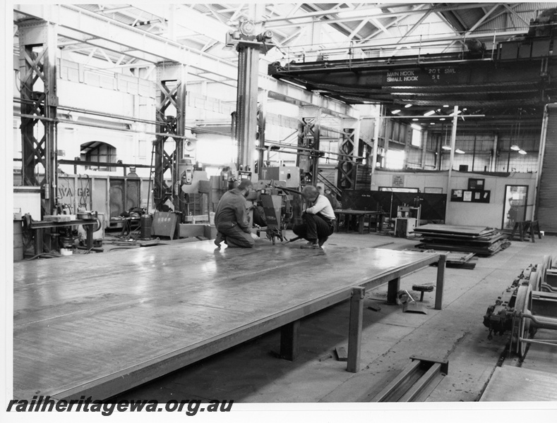 P10814
Welding sidewall sheets for XW class wagons, workers shown are boilermaker M. Wilkins (on left) and apprentice Gary West (on the right), overhead crane, boiler shop store at rear of view, Boiler Shop South (east end), Midland Workshops
