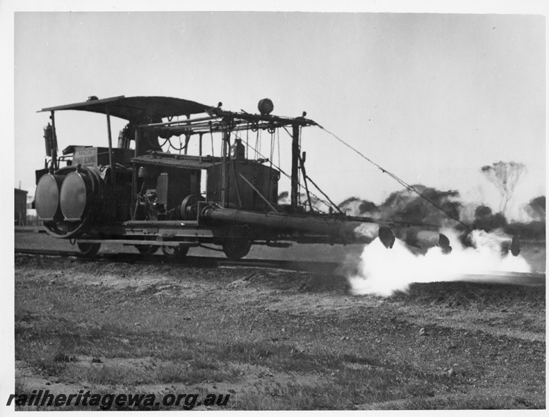 P10820
Woolery weed burner, in operation on track, side and end view

