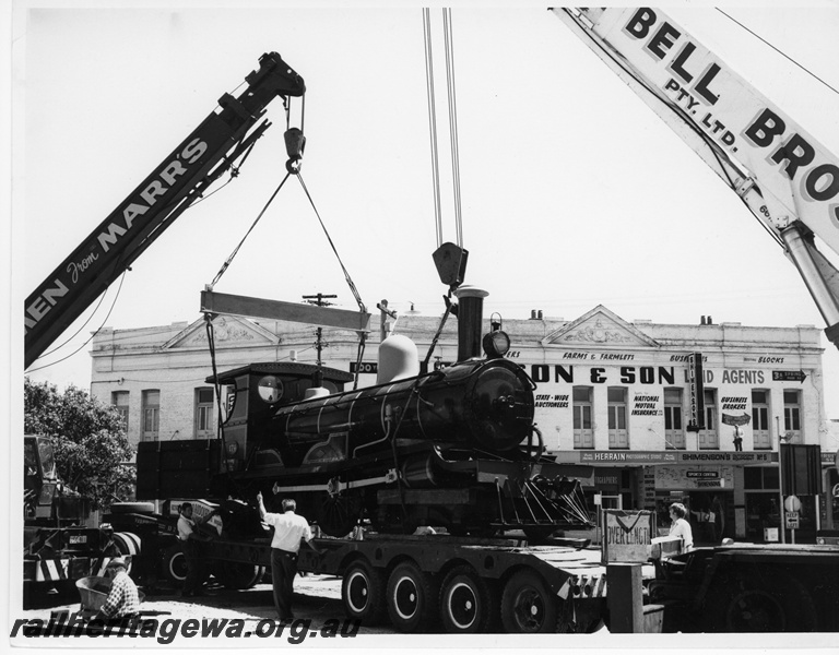 P10837
Placement of R class 174 on display outside Centrepoint No 2 of 3 images, loco (side and front view) being lifted off road trailer by 