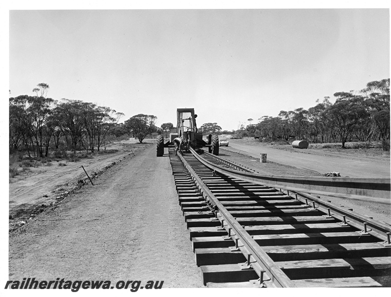 P10857
Track laying tractor in operation, worker, rural setting, track level view
