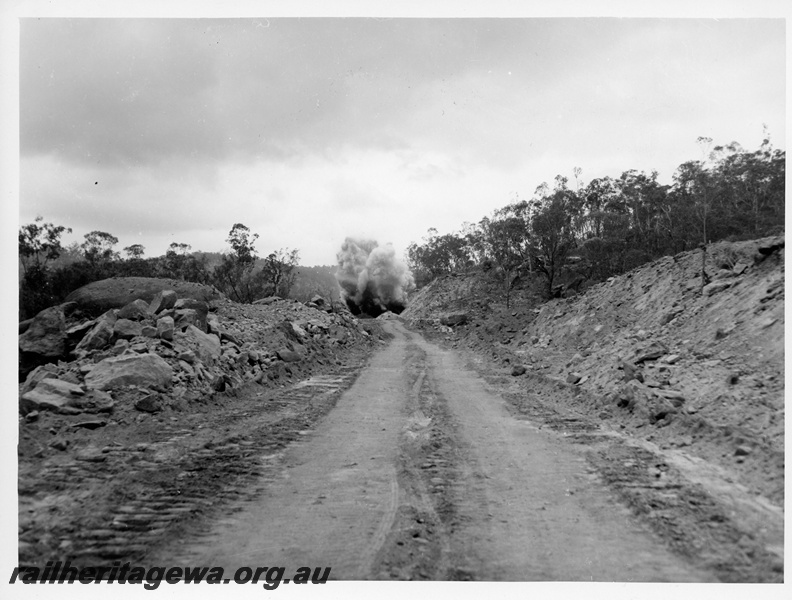 P10858
Blasting a cutting, cloud of dust and smoke, rural setting, view from a distance
