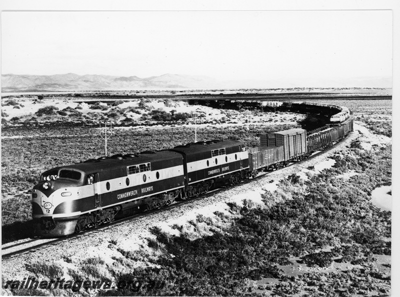 P10884
A Commonwealth Railways (CR) westbound standard gauge freight train, hauled by GM class 12 and GM class 36 diesel locomotives, rounding the 'S' curves at Yorkeys Crossing west of Port Augusta, TAR line.
