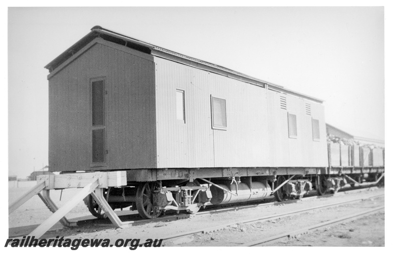 P10888
An unidentified R class flat wagon with a mobile fettling gang accommodation unit as a load. An unidentified open wagon, loaded with equipment, is marshalled next.
