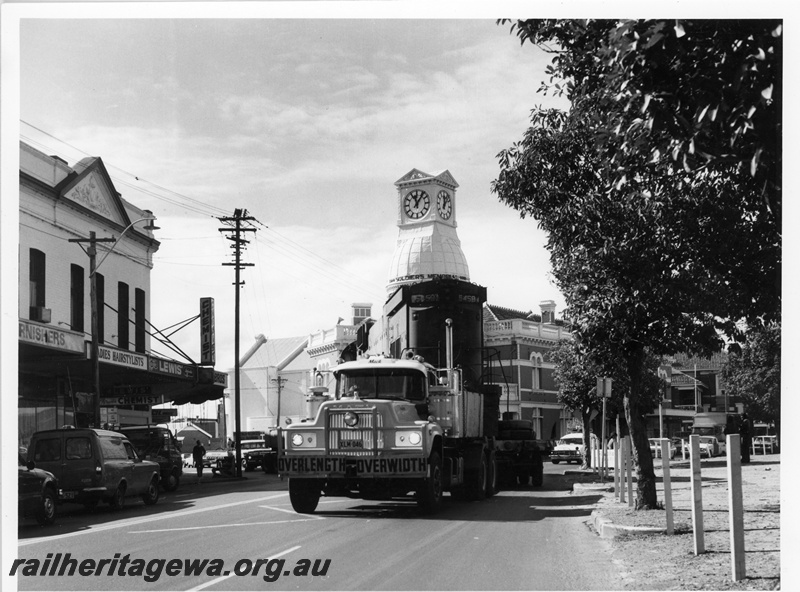 P10897
Mount Newman (MNM) C636 class 5458 on road transporter at the corner of Great Eastern Hwy and Great Northern Hwy Midland - Midland Town Hall in background. Locomotive enroute to Tomlinson Steel Welshpool for rebuilding.
