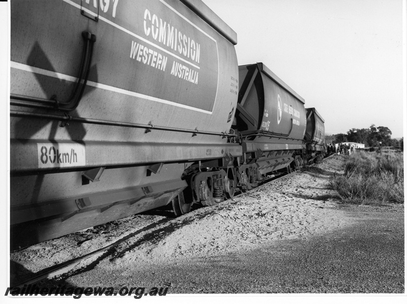 P10952
5 of 7. Derailed XG class hopper wagons and two remaining on the trackat Wagerup, SWR Line.view alonf the line of wagons. Date of derailment 11/9/1981.

