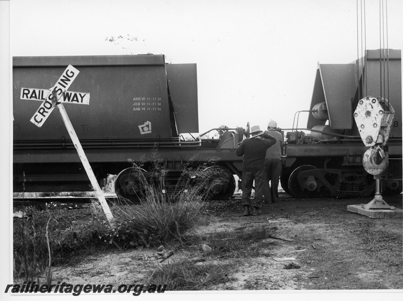 P10953
6 of 7. Mechanical staff about to uncouple two wagons to allow a road crane to lift the wagon to the right back onto the rails to enable it to clear the site at Wagerup, SWR line. Date of derailment 11/9/1981 

