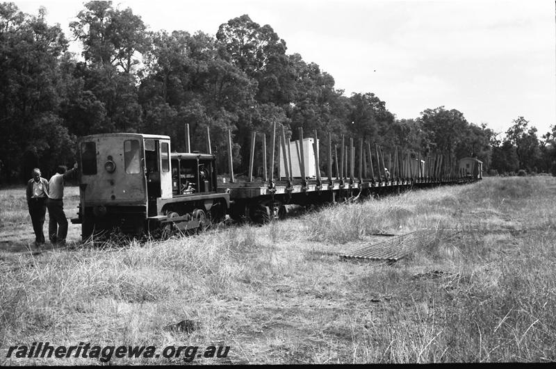 P11120
Mill diesel loco, in the Nannup yard, WN line, coupled to a rake of empty timber bogie flat wagons, end and side view of the loco
