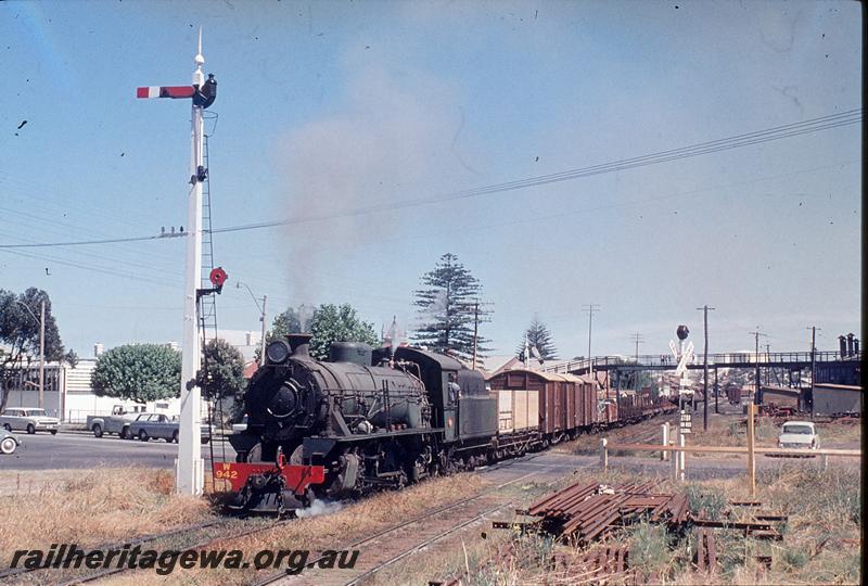 P11785
W class 942, goods train, signals, level crossing, footbridge, part of roundhouse, departing Bunbury. SWR line.
