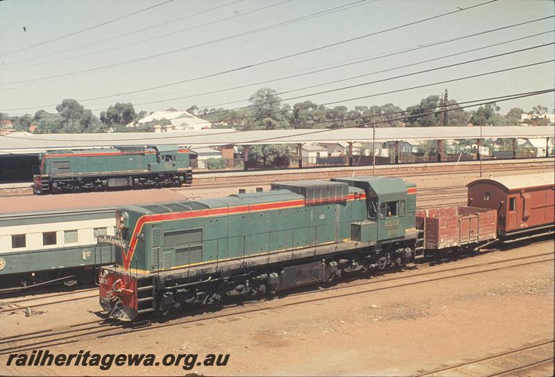 P11917
AA class 1517, shunting Kalgoorlie yard, coupled to GE class 12044 and a Z class brakevan in the brown livery with a yellow roof, AA class 1516 in background
