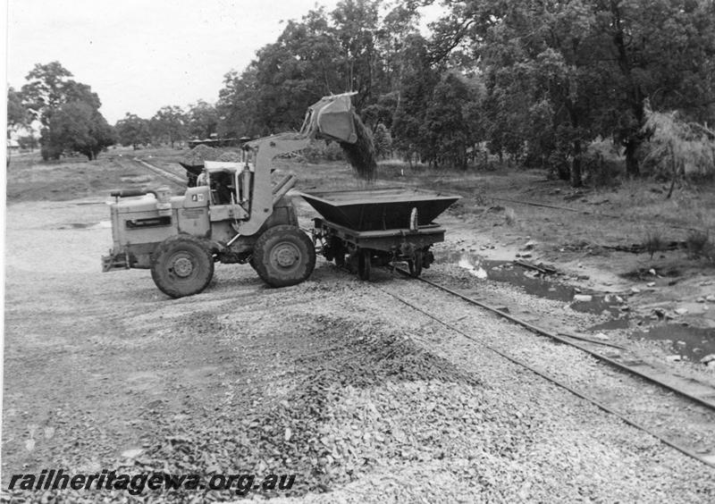 P12029
7 of 12 images of the construction of the Kwinana to Jarrahdale railway. (ref: The Railway Institute Magazine, July 1963).LA class ballast wagon being loaded with ballast by a front end loader
