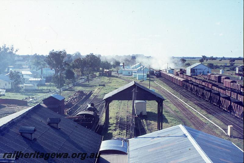 P12277
ADF class on Bunbury Belle in Pinjarra platform, PMR class 724 in Pinjarra loco shed, station buildings, platform, goods shed, from southern water tower. SWR line.
