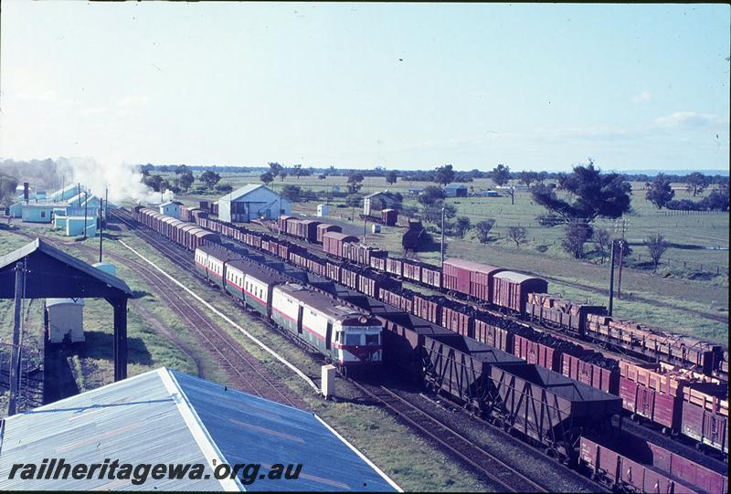 P12278
ADF class on Bunbury Belle leaving Pinjarra, station buildings, platform, goods shed, from southern water tower. SWR line.
