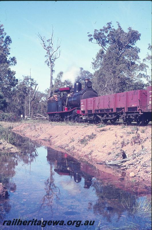 P12322
YX class 86 on train, R class bogie open wagon with angle iron truss rods trailing the loco, Yornup.
