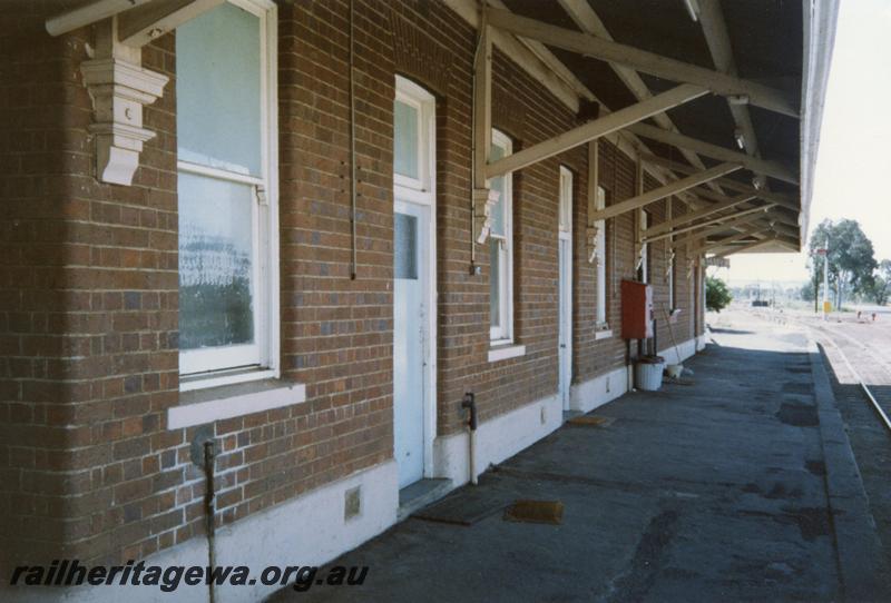 P12523
Station building, Wagin, GSR line, view along the side of the building showing platform and roof rafters
