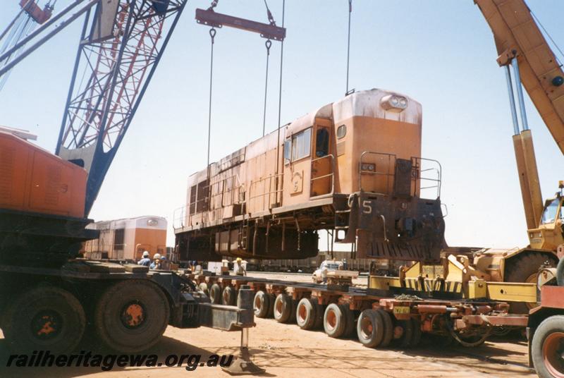 P12536
Port Hedland Nelson Point yard, Goldsworthy Mining A class English Electric No.5 being loaded onto a Bell road float for transporting to Perth
