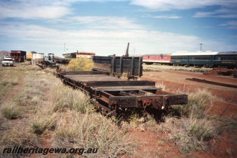 P12575
Jetty wagon, bogie flat wagon with missing deck planks, Pilbara Railway Historical Society museum, Dampier, end and side view

