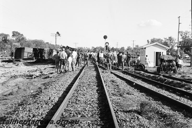 P12772
Derailment at Mundijong, relay cabin, wagons laying on their side, crowd on the tracks
