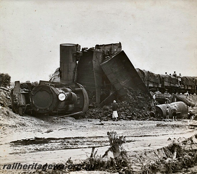 P12922
1 of 8 images of a derailment at Dumberning, BN line, F class loco laying on its side, wagons piled up and onlookers climbing on the wagons. Date of derailment 14/3/1934
