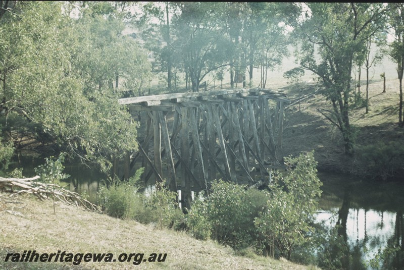 P13272
Trestle bridge Kauri Timber Co. over the Blackwood River west of Nannup. since destroyed by a flood in 1982
