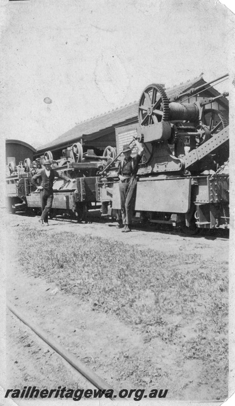 P13513
Cowans Sheldon six wheel hand crane, H class wagons with upturned ballast hoppers on board probably as a result of a derailment, date and location Unknown. 
