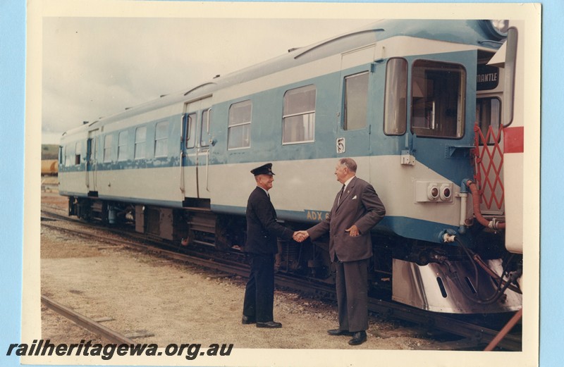 P13578
ADX class 670 in experimental blue livery, Commissioner of Railways Mr. C. G. C. Wayne shaking hands with an employee, side and front view.
