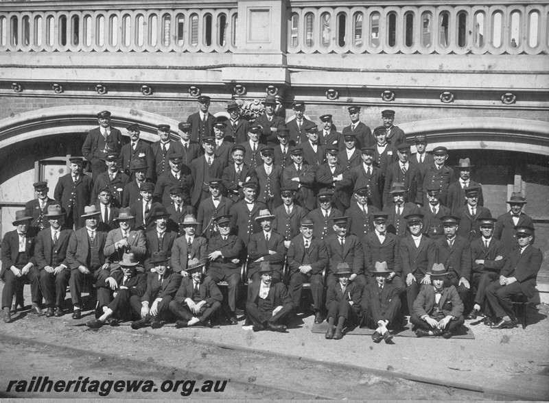 P13765
Railway employees from the Perth Parcels Office, group photo taken in front of the offices under the 