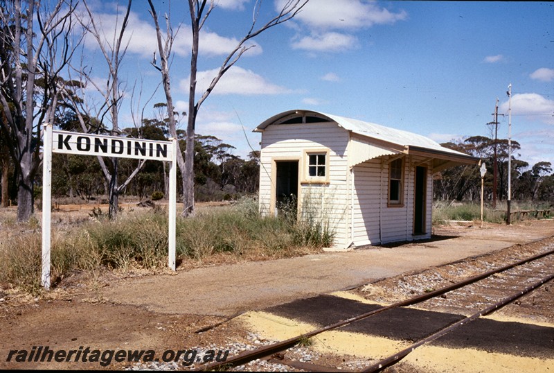 P13844
3 of 7 views of the structures in the station precinct, Kondinin, NKM line, nameboard, shelter shed, end and trackside view
