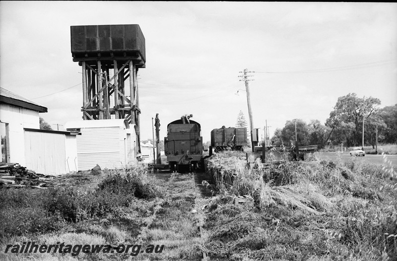P13952
29 of 32 images of the railway and jetty precincts of Busselton, BB line, W class 921, water column, water tower, loco depot, wagon on the coaling platform, end on rear view.
