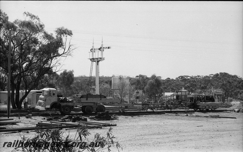 P13991
Rail service vehicle converted from a road vehicle with six wheels under the front unit and a bogie from an ADU/AYU class carriage under the trailer unit, bracket signal Goomalling, EM line
