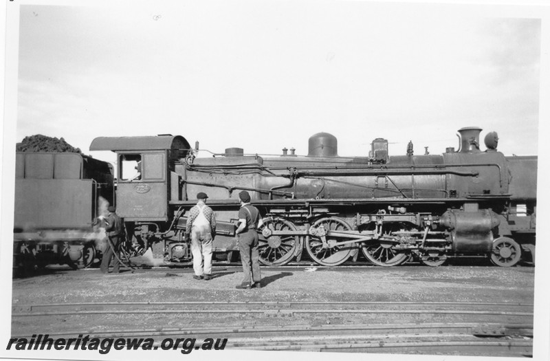 P14201
PMR class 724with shed driver R. Durbridge and shed fireman L. Williams standing in front of the loco, Kalgoorlie loco depot, EGR line, side view 
